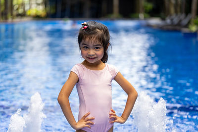 Portrait of cute girl standing in swimming pool