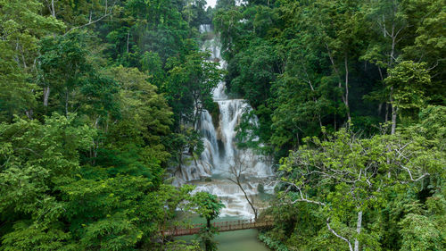 Aerial view tat kuang si waterfall in luang prabang, laos, beautiful waterfall in jungle.