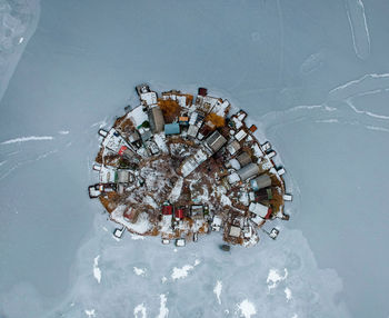 Aerial view of land amidst frozen lake