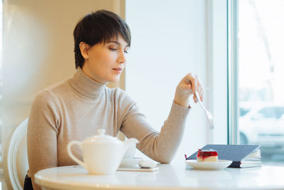 Young woman sitting on table