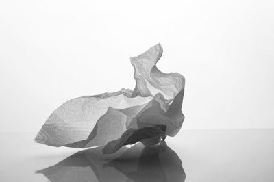 Close-up of paper skull against white background