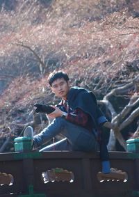 Portrait of young man sitting outdoors