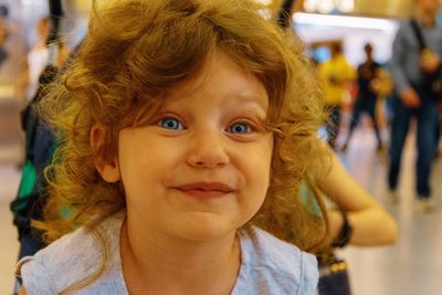 Close-up portrait of cute girl with blue eyes