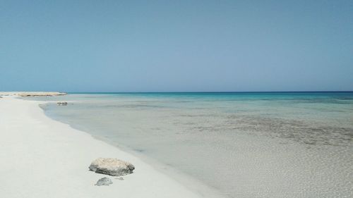 Scenic view of beach against clear sky