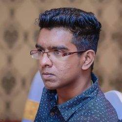 Close-up of young man in eyeglasses looking away