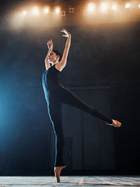 Full length of female ballet dancer performing on stage