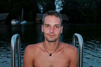 Portrait of handsome young man in swimming pool