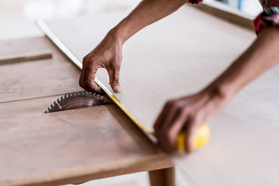 Midsection of person working on wood