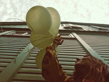 Portrait of girl with umbrella on window