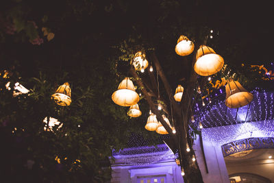 Low angle view of illuminated lanterns at night