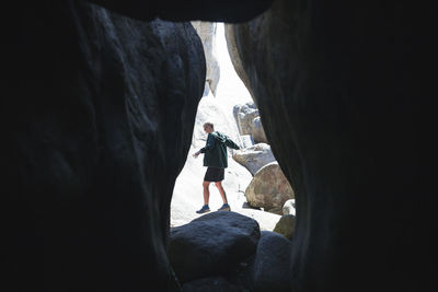 Man standing in cave at seaside