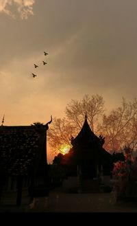 Silhouette temple against sky during sunset