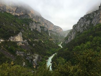 Scenic view of mountains against cloudy sky