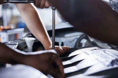 Low section of man repairing car