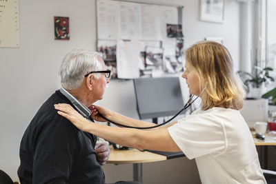 Doctor examining senior patient