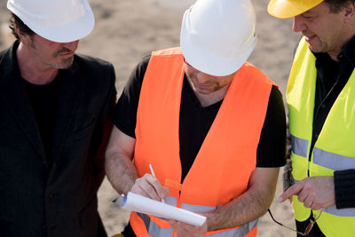 Coworkers working at construction site