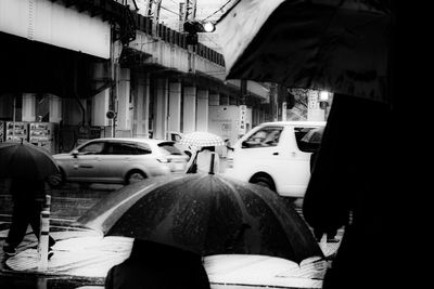 Rear view of people on wet street in rainy season