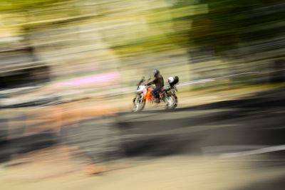 Blurred motion of people riding bicycle