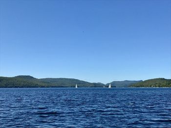 Scenic view of sea against clear blue sky