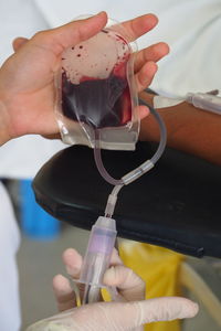 Cropped image of doctor and patient at blood bank