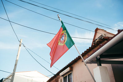 Low angle view of flags hanging against sky