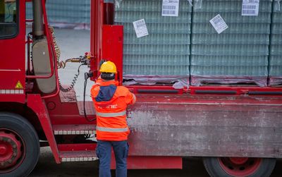 Man working on red bus