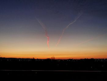 Silhouette lightning against sky at sunset