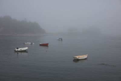 Boats in sea against sky