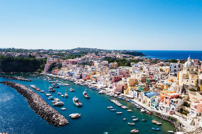 High angle view of moored boats against town