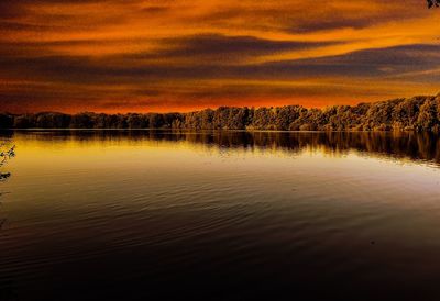 Scenic view of lake against orange sky