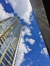 Low angle view of modern building against cloudy sky