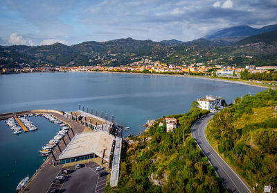 High angle view of city by sea against sky