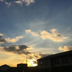 Low angle view of city against sky during sunset