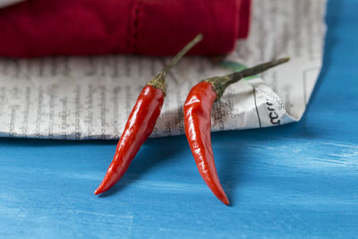 Close-up of red chili peppers on table