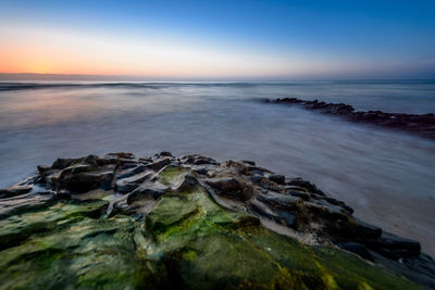 Scenic view of sea against sky at sunset