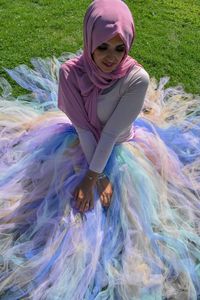 High angle view of woman wearing hijab sitting on land