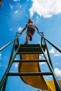 Low angle view of child on slide