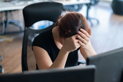 Rear view of woman using mobile phone