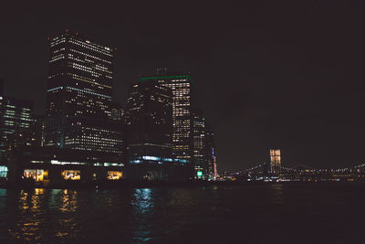 Low angle view of illuminated city lit up at night