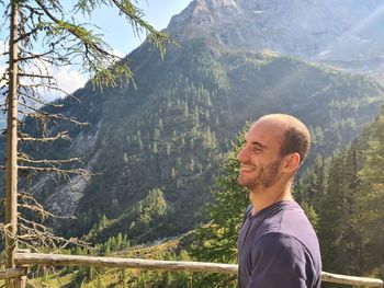 Portrait of young man against mountains