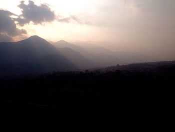 Scenic view of silhouette mountains against sky at sunset