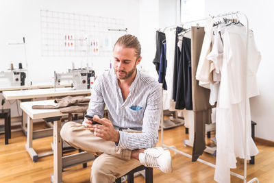 Male fashion designer working at boutique