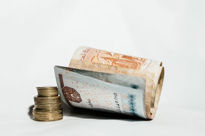 Close-up of coin stack against white background