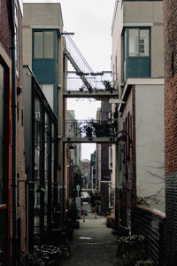 Narrow street amidst buildings in city