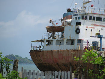 Ship moored in sea against sky