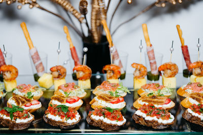 Rye bread bruschetta, cream cheese and salmon, shrimp and pineapple canapes on skewers