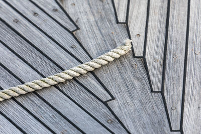 Close-up of rope on wooden pier