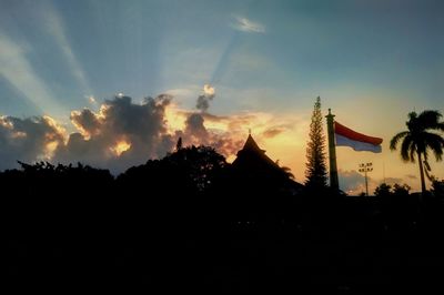 Silhouette of buildings against cloudy sky