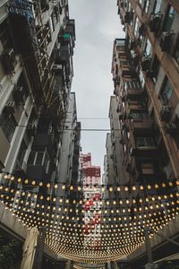 Low angle view of illuminated buildings against sky in city