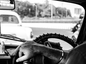 Man seen through car windshield